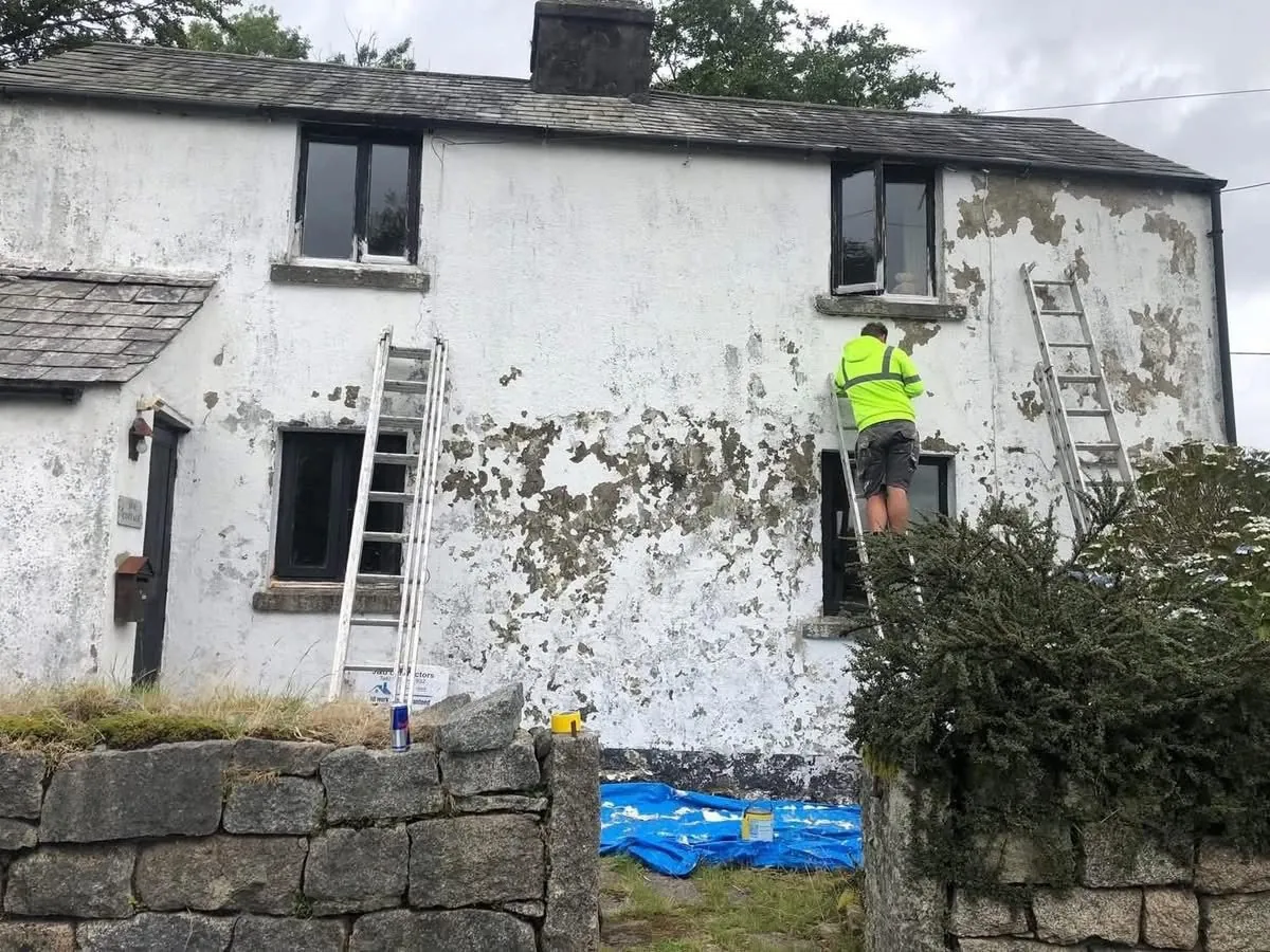 Cottage with blown, flaking render before repair in Marazion